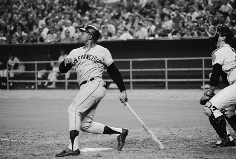 Willie Mays hits baseball home run.