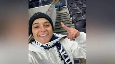 Mandy Damari Family handout showing Emily Damari wearing a Tottenham Hotspur scarf at a football match