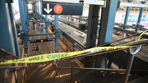 Getty Images Police investigate at the Coney Island-Stillwell Avenue Station in Brooklyn after a woman aboard a subway car was set on fire and died