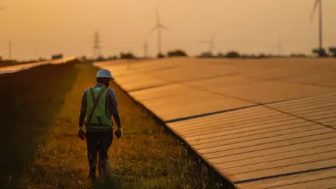 Getty Images A maintenance worker inspects solar panels at a solar power plant operated by Ayana Renewable Power Pvt. in Tuticorin, India, on Wednesday, March 20, 2024. 