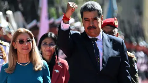 Getty Images Venezuela's President Nicolas Maduro (R) gestures next to First Lady Cilia Flores on arrival at the Capitolio -house of the National Assembly- for the presidential inauguration, in Caracas on January 10, 2025