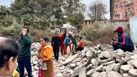 Getty Images Nepalese residents gathering outdoors in a neighbourhood