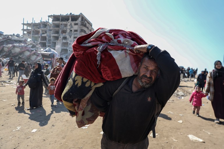 Man carries belongings on his shoulder