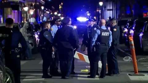 Reuters Police stand in dark at attack scene in new orleans.
