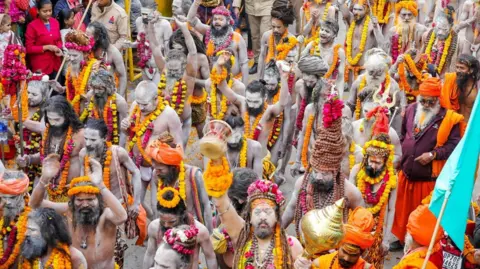 Ankit Srinivas Dozens of holy men walking in a parade at the festival