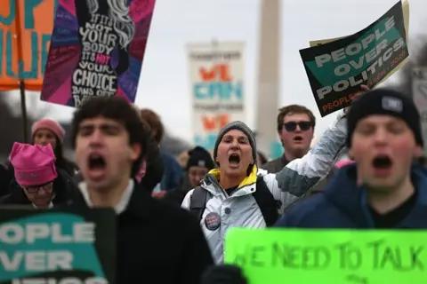 Getty Images Protesters yell during the People's March