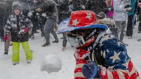 Getty Images Man in US flag colours participating in the snowball fight in Washington DC's Meridian Hill Park 