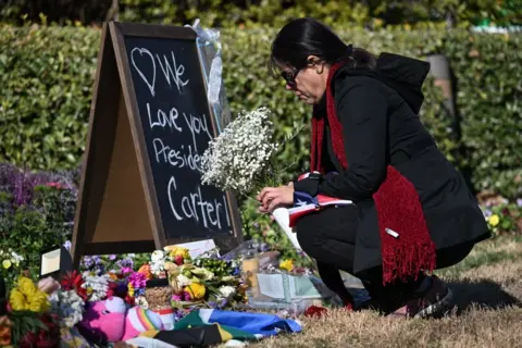 Reuters Mourner outside Carter Center